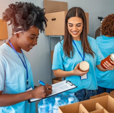 Image of 3 women doing inventory at a local food bank.