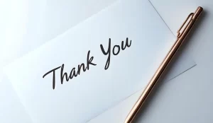 Thank you card with a gold pen.