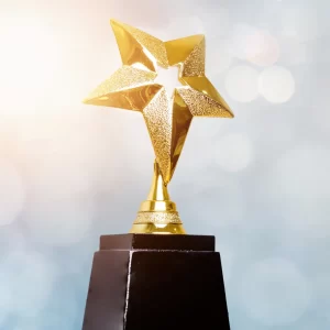 Award image of a star on top of a trophy.