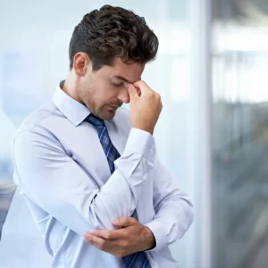 Man frustrated with his hand on his head.